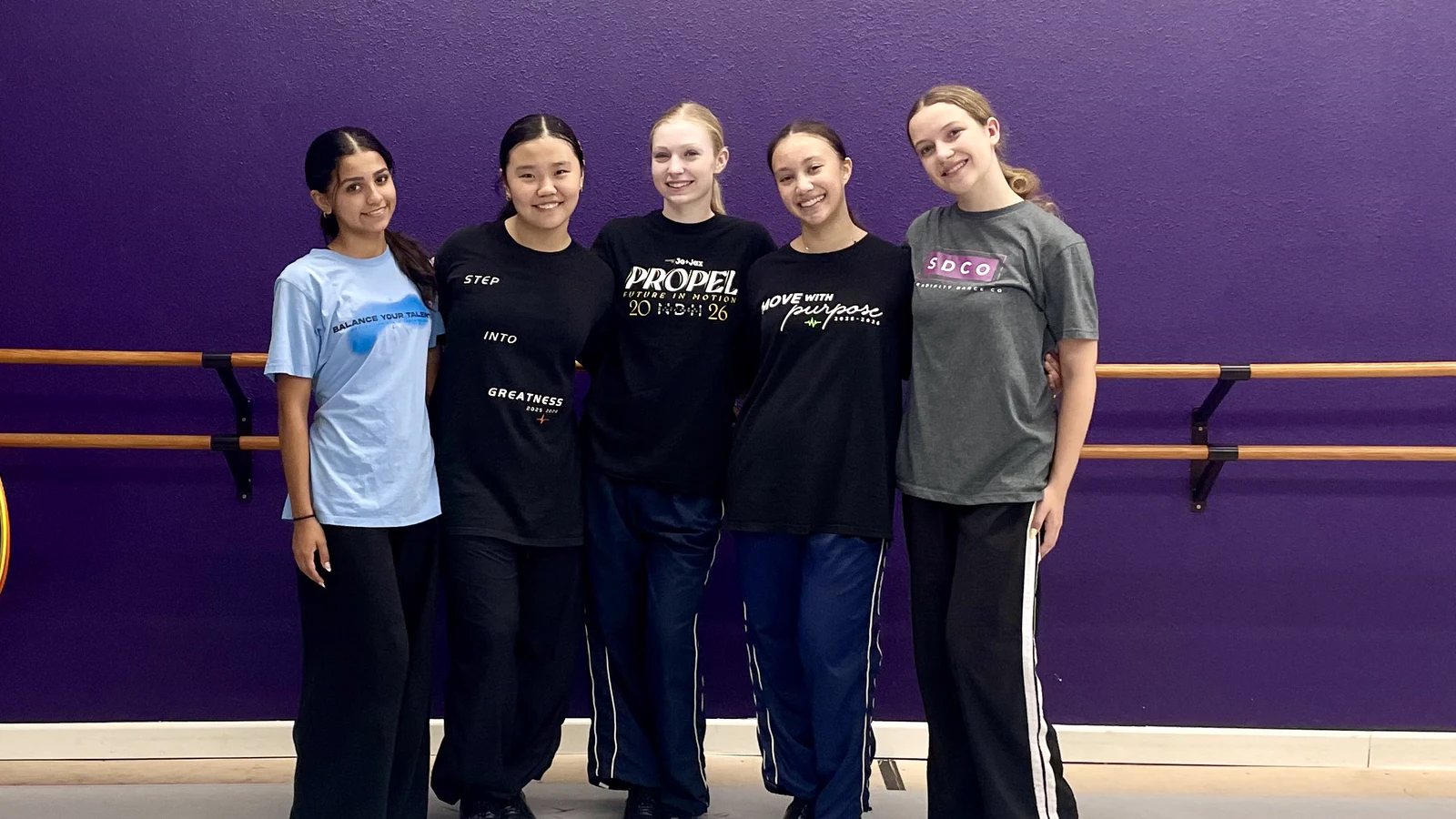 Five happy teen tap dancers smiling together in the Serendipity studio