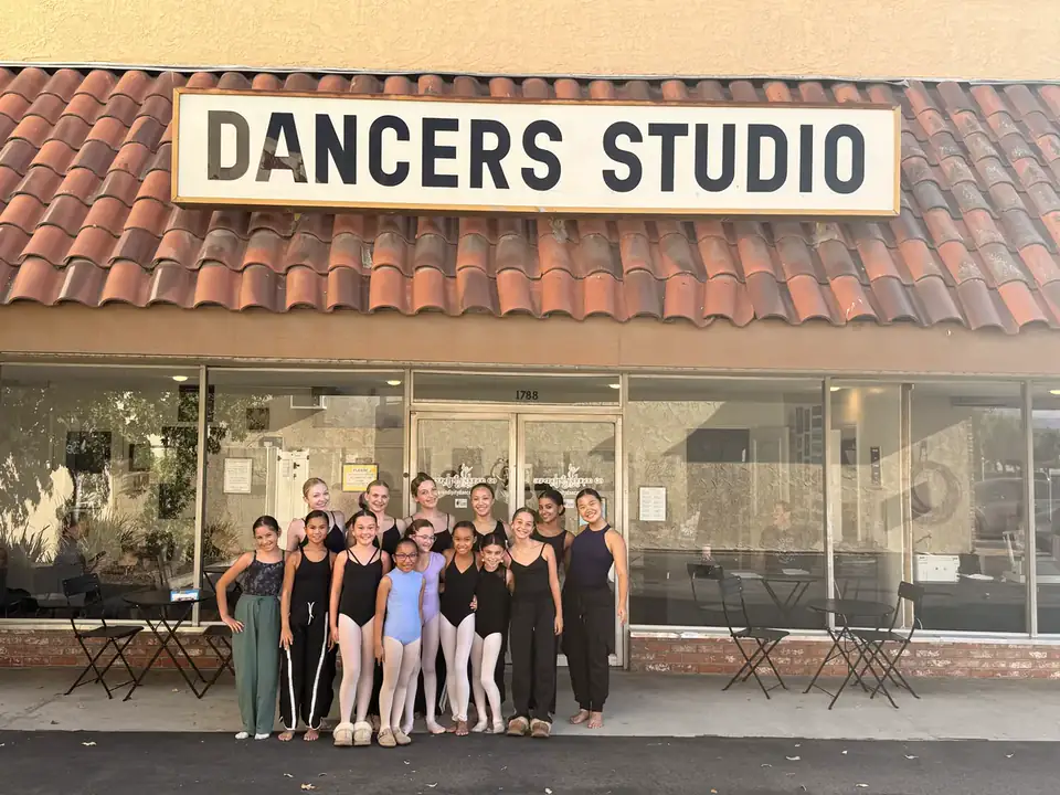 Dancers outside the Serendipity studio entrance beneath the Dancers Studio sign